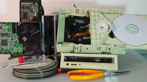 Stack of old SATA, ATA hard disk drives and driver cd disassembled. Stock-Footage 106501970