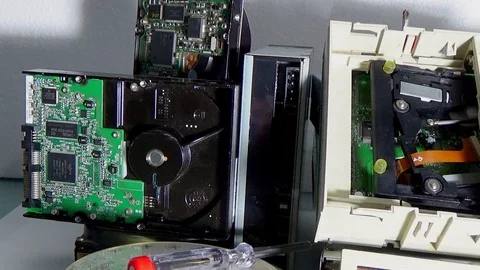 Stack of old SATA, ATA hard disk drives and driver cd disassembled. Stock-Footage 106502362