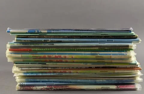 Stack of old school exercise books on a gray background. Random thin notebook Stock Photos