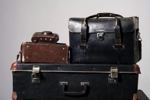 Stack of old shabby suitcase with a camera in bag Stock Photos
