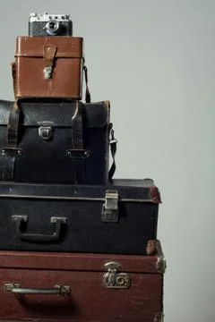 Stack of old shabby suitcases and camera Stock Photos