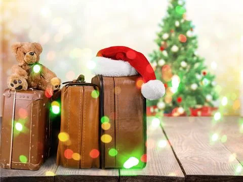 Stack of Old suitcases with teddy bear and santa hat . Travelling concept Stock Photos