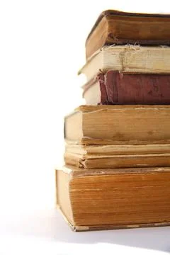 A stack of old tattered books on a white background. Pyramid of old books Stock-Fotos