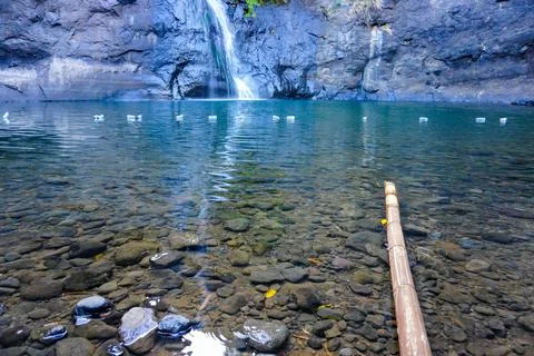 Stack of Old Tires Against Rusty Fence Outdoors Photos