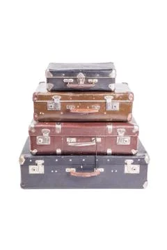 Stack of old vintage suitcases isolated on white Stock Photos