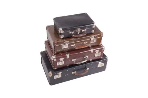 Stack of old vintage suitcases isolated on white Stock Photos