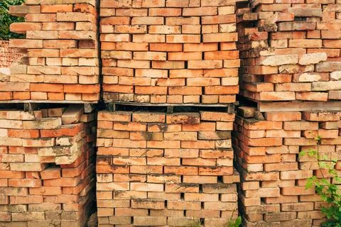 Stack of old weathered bricks used for construction or recycling. Stock Photos