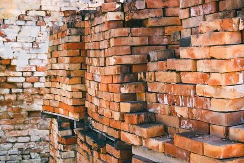 Stack of old work bricks on construction site 写真素材