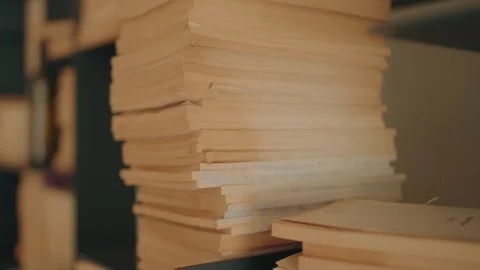 Stack of old yellowed papers and documents in warm light Stock Footage 318515674