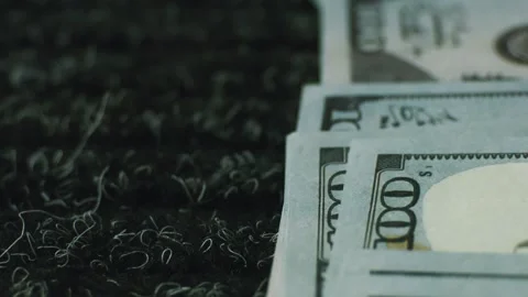 Stack of one hundred dollar bills resting on textured black carpet backgrou.. Stock Footage 337546783