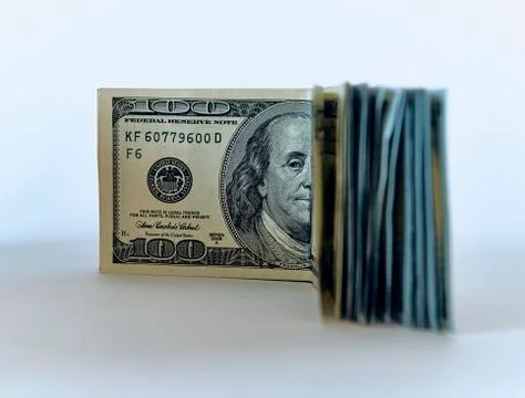 Stack of one hundred dollar bills new design on a white background - The Pres Stock Photos