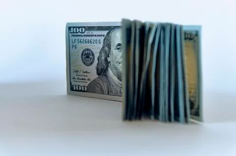 Stack of one hundred dollar bills new design on a white background - The Pres Stock Photos