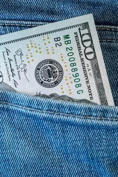 Stack of One Hundred Dollar Bills in Back Jeans Pocket. Hidden Cash, Person.. Stock Photos
