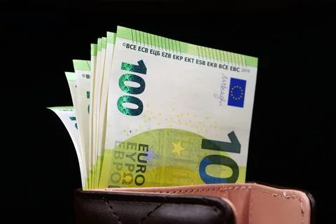 Stack of one hundred Euro banknotes in a black wallet, symbolizing savings .. Stock Photos