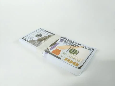 Stack of one hundred US dollar bills neatly wrapped with a paper band Stock Photos