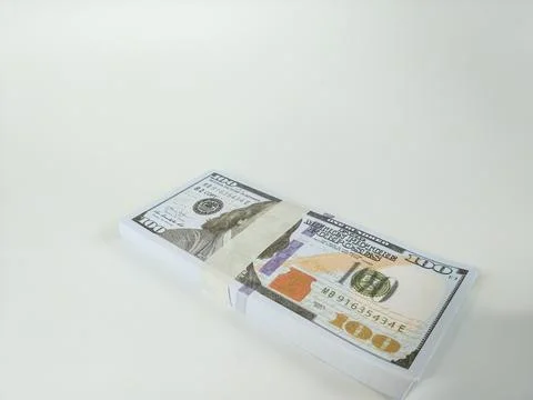 Stack of one hundred US dollar bills neatly wrapped with a paper band Stock Photos