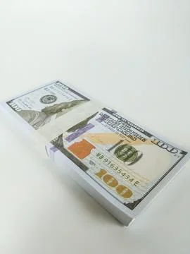 Stack of one hundred US dollar bills neatly wrapped with a paper band Stock Photos
