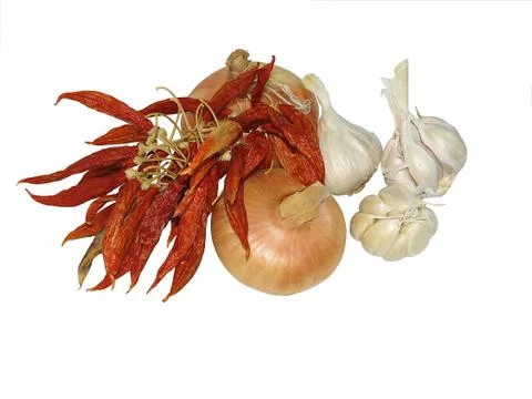 Stack of onions, chilli, garlic Stock Photos
