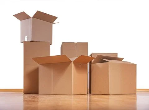 A stack of open and closed cardboard boxes against a white background. Stock Photos