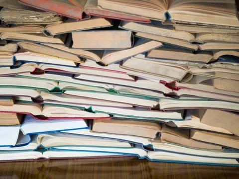 A stack of opened book, lying on the table. Knowlege and education concept. Фото