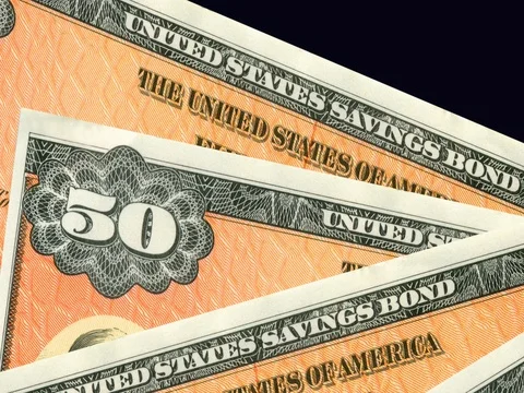 Stack of orange $50 paper United States savings bonds. Stock Footage 76586787