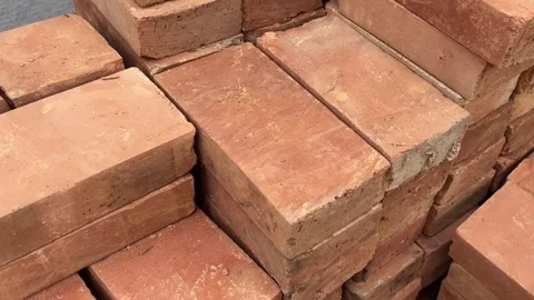Stack of orange bricks arranged in rows with rough texture Stock Footage 314098478