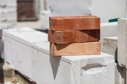 Stack of orange bricks on construction site Stock Photos