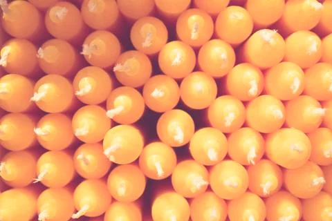 Stack of orange candles creates a pattern Stock Photos
