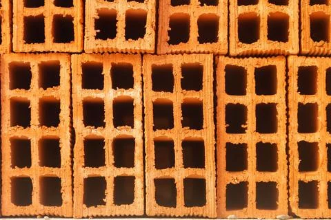 Stack of orange construction bricks stacked on top of each other Stock Photos