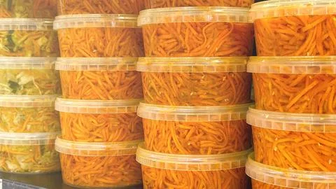 A stack of orange containers with a white lid Stock Photos
