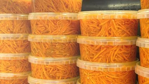A stack of orange containers with a yellow substance inside Stock Photos