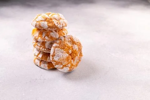 Stack of orange crinkle cookies with powdered sugar 스톡 사진