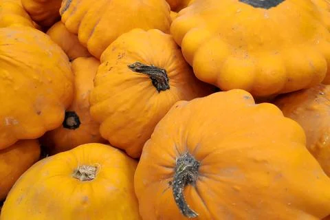 Stack of orange pattypan squashes on a market stall Stock Photos