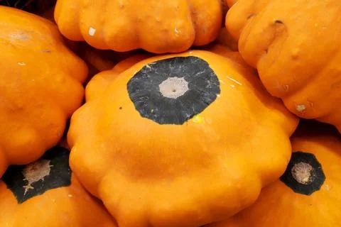 Stack of orange pattypan squashes on a market stall Stock Photos