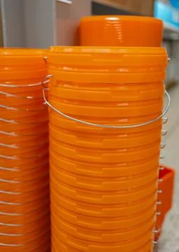 Stack of orange plastic buckets Foto stock
