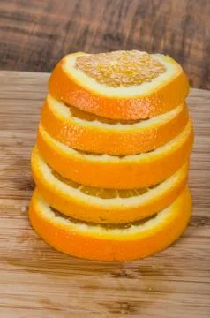 Stack of orange slices on board 写真素材