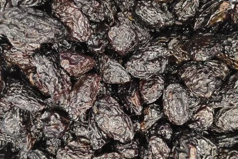 Stack of organic dried plums in a market stall Fotos de archivo