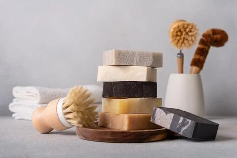 Stack of organic soap bars and bamboo dish brushes. Kitchen cleaning concept. 写真素材