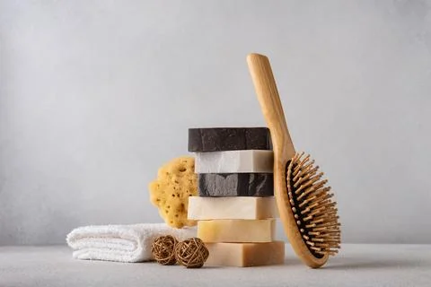 Stack of organic soap bars, bamboo hair comb, natural sponge and cotton towel 写真素材