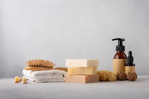 Stack of organic soap bars, bamboo hair comb, cosmetic bottles, natural spong 写真素材
