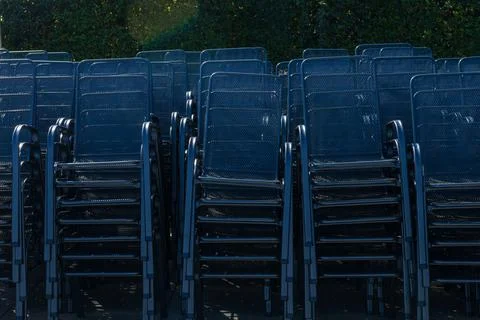Stack of Outdoor Metal Chairs Arranged for Storage 库存照片