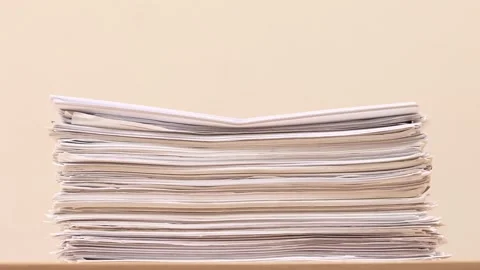 Stack of overload document paper on wooden table - Stop motion animation 스톡 동영상 145434162
