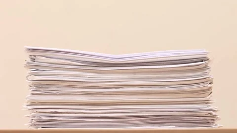Stack of overload document paper on wooden table - Stop motion animation Stock Footage 161086602