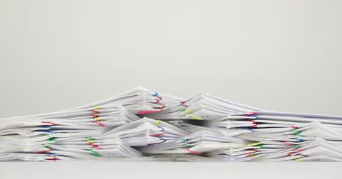 Stack overload document of report on white table time lapse 動画素材 62536789