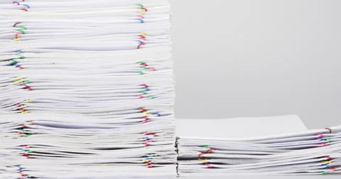 Stack overload paper on white table time lapse 스톡 동영상 61782165
