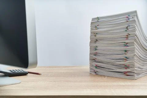 Stack of overload paperwork report of sale with colorful paper clip and penci Foto stock