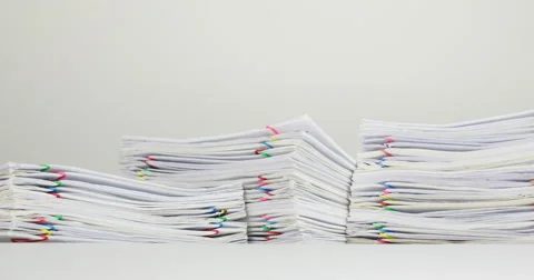 Stack overload paperwork on white table time lapse 動画素材 61382002