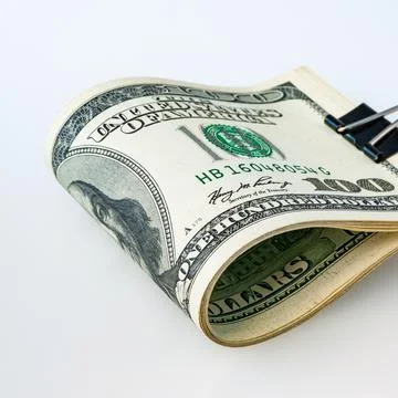 A stack of packaged dollars on a white background. One hundred American dolla Stock Photos