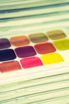 Stack of packages with different colors - watercolor for the artist. Toned. V Stock Photos