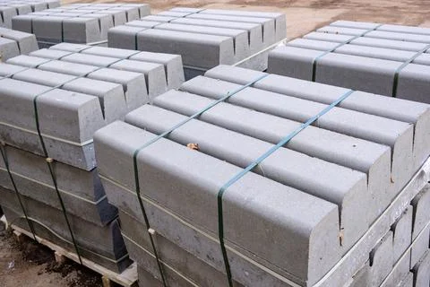 Stack of packed border stones for asphalt road on wooden pallet Stock Photos